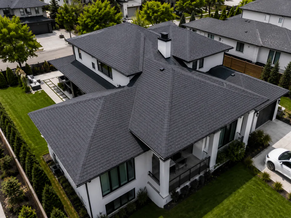 Clean dark-shingle roof shown before storm damage
